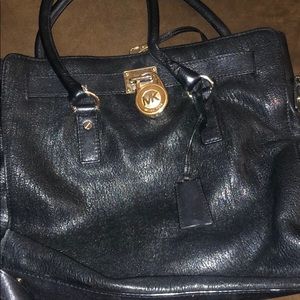 Michael Kors bag with gold lock.